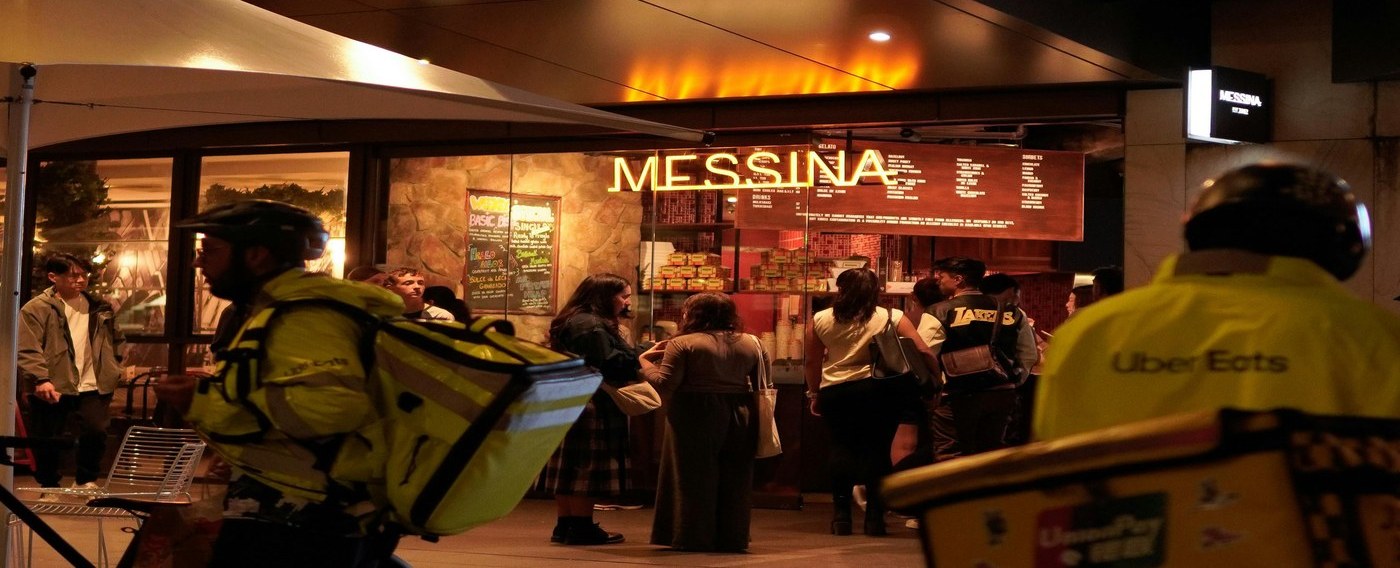 Delivery riders outside Messina at night